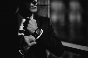 Stock photograph of a businessman straightening his tie